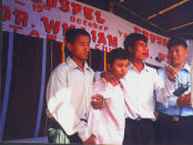 Boy born blind (2nd from left) begins to see in above Open-air Crusade